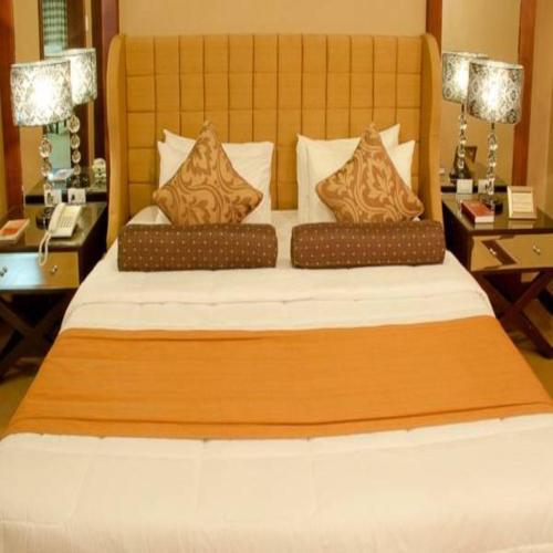 a bedroom with a large bed with two night stands at Royal Garden Hotel in Ozamis