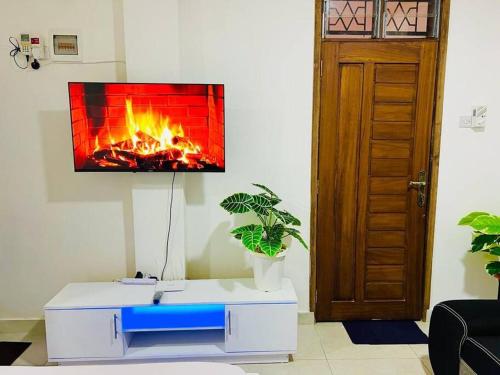 a living room with a fireplace on the wall at Studio Apartment Bamburi0711519879 Near JSB BlockA in Mombasa