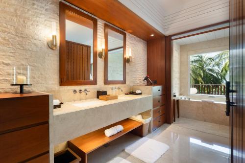 a bathroom with a large sink and a large window at Mandarin Oriental, Sanya in Sanya
