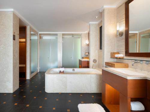 a large bathroom with a tub and two sinks at Mandarin Oriental, Sanya in Sanya