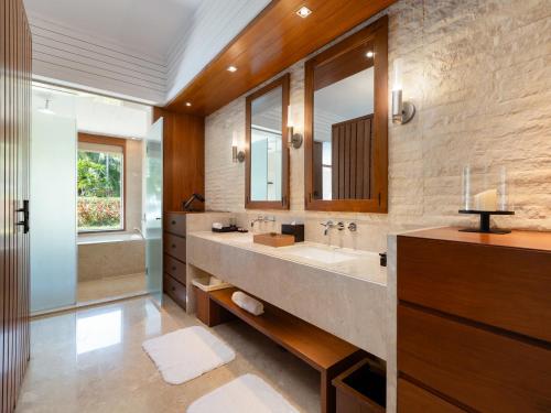 a bathroom with a large sink and a large mirror at Mandarin Oriental, Sanya in Sanya