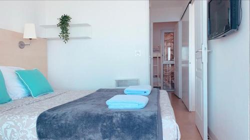 a bedroom with a large bed with blue pillows at COSTA PLANA - Unique Apartment for 8 PAX in Cap d'Ail