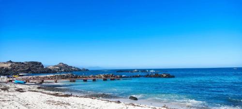 a group of people on a pier in the ocean at Cabañas Tres Islas in Punta de Choros