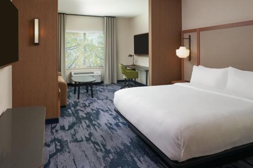 a hotel room with a large bed and a desk at Fairfield by Marriott Inn & Suites Hardeeville I-95 North in Hardeeville