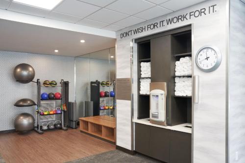 a gym with a clock on a wall at Fairfield by Marriott Inn & Suites Hardeeville I-95 North in Hardeeville
