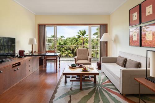 a living room with a couch and a table at Mandarin Oriental, Sanya in Sanya