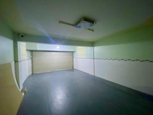 a large empty room with a garage door and a ceiling at Lagi Sunrise Hotel in La Gi