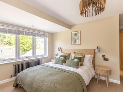 a bedroom with a bed and a window at Langdale Boulders in Ambleside