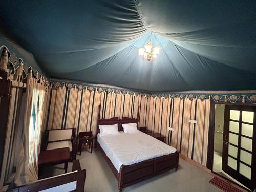 a bedroom with a bed in a tent at Royal Rajasthan Resort in Sīkar