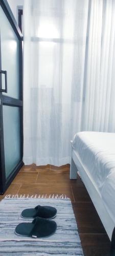 a hat on a rug in a bedroom with a bed at Dukes Suites in Nairobi