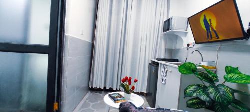 a small room with a table with flowers on it at Dukes Suites in Nairobi