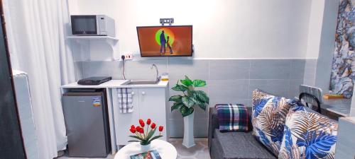 a small living room with a couch and a sink at Dukes Suites in Nairobi