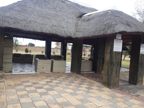 a building with a thatched roof with windows at Loding Lodge in Loding