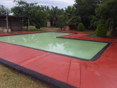 a pool of water on a red and green floor at Loding Lodge in Loding