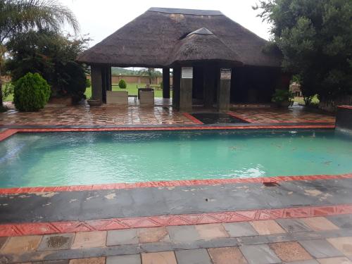 a swimming pool with a gazebo at Loding Lodge in Loding