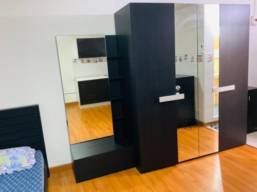 a room with a black door and a mirror at Dailyroom by Anna T1-T12 in Nonthaburi