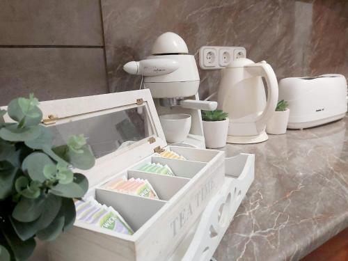 a toy robot sitting next to a table with a white container at L&eacute;na Apartman - Eger in Eger