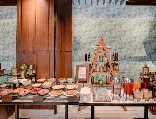 a table with many different types of food on it at Hyatt Ahmedabad in Ahmedabad