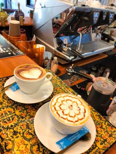 two cups of coffee sitting on a table at SAMED GRAY HOUSE in Ban Phe