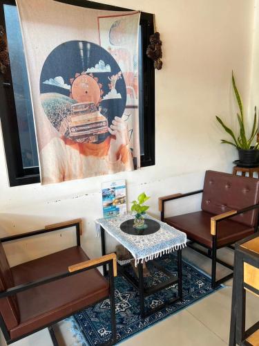 a living room with two chairs and a table at SAMED GRAY HOUSE in Ban Phe
