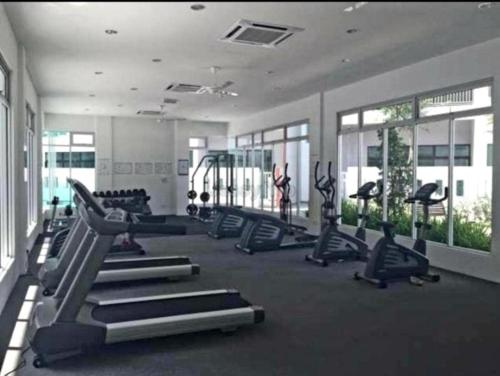 a gym with treadmills and machines in a room at JB Austin Regency @ Simple Tidy Comfort 7 pax in Johor Bahru
