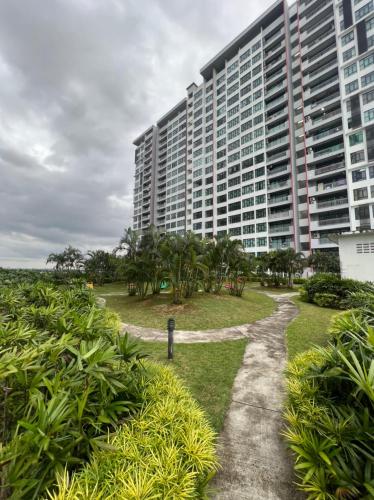 a large building with a path in front of it at JB Austin Regency @ Simple Tidy Comfort 7 pax in Johor Bahru