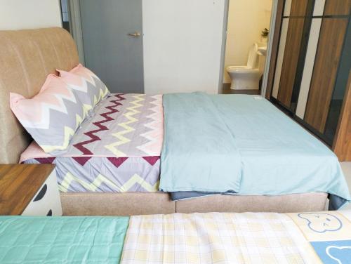 a bedroom with two beds and a bedskirts at JB Austin Regency @ Simple Tidy Comfort 7 pax in Johor Bahru
