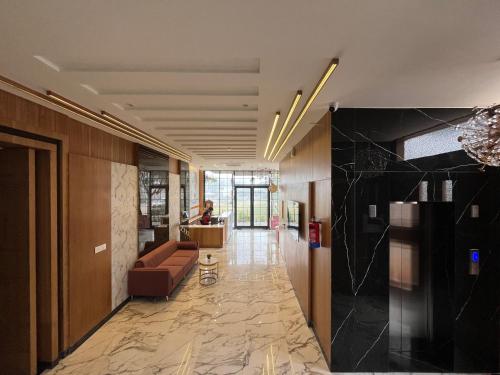 a lobby with a couch and a table in a room at Hotel Three Seasons in Vrindāvan