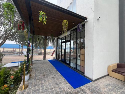 a house with a blue carpet on a patio at Hotel Three Seasons in Vrindāvan