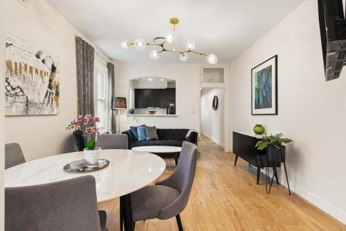 a living room with a table and a couch at Boutique Apartment With Private Roof Terrace in Sydney