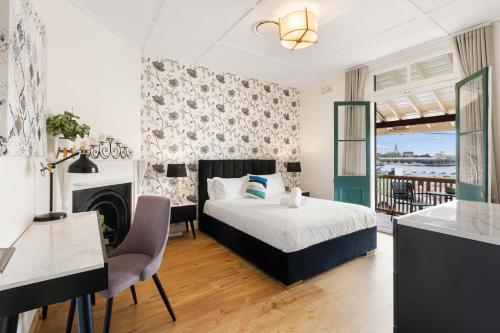 a bedroom with a bed and a table and chairs at Boutique Apartment With Private Roof Terrace in Sydney