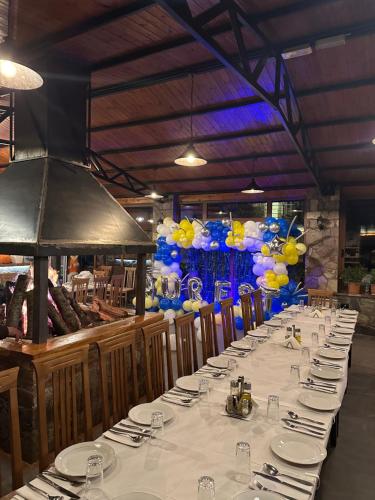 a long table with plates and balloons on it at VILA DISHA in Tirana