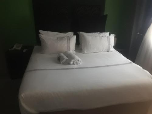 a teddy bear sitting on top of a bed at Loding Lodge in Loding