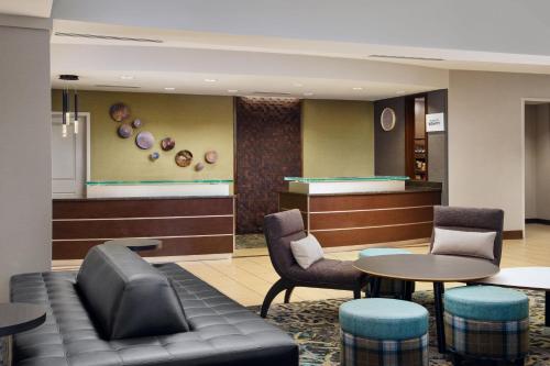 a waiting room with a couch and a table and chairs at Residence Inn by Marriott Fort Myers at I-75 and Gulf Coast Town Center in Estero