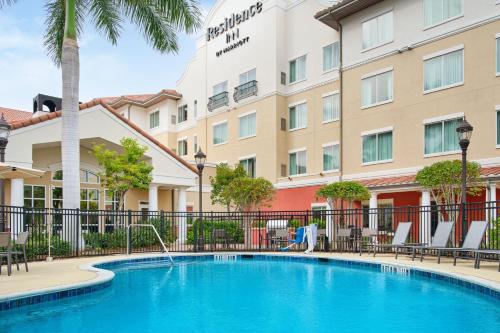 a hotel with a swimming pool in front of a building at Residence Inn by Marriott Fort Myers at I-75 and Gulf Coast Town Center in Estero