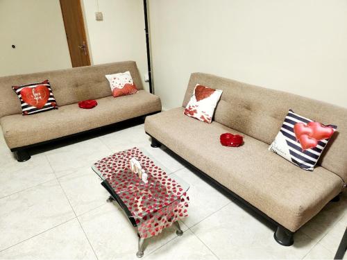 a living room with two couches and a coffee table at Kot Nu - Beach Themed Apartment - 3 mins walk from the sea in Flic-en-Flac