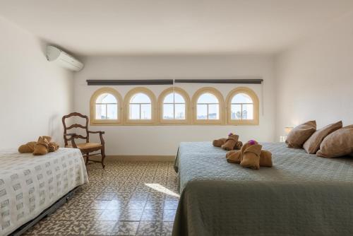 two beds with stuffed animals on them in a room at Villa Maresme in Cabrils