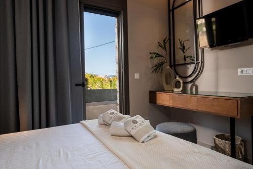 a hotel room with a bed with towels on it at Horizon Apartments - Beachfront Luxury, by ZanteWize in Laganas