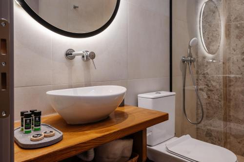 a bathroom with a sink and a toilet and a shower at Horizon Apartments - Beachfront Luxury, by ZanteWize in Laganas