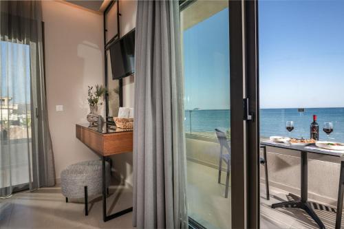 a room with a balcony with a view of the ocean at Horizon Apartments - Beachfront Luxury, by ZanteWize in Laganas