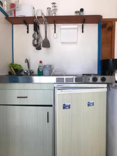 a kitchen with a sink and a stove top oven at Oleander's Garden Traditional Cretan Cottage in Ferma