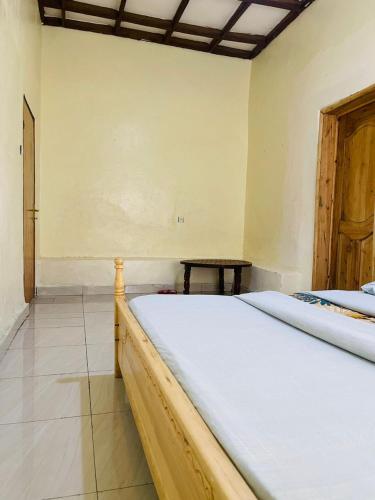 ein Schlafzimmer mit einem Bett und einem Tisch darin in der Unterkunft Ignite guest house in Gisenyi