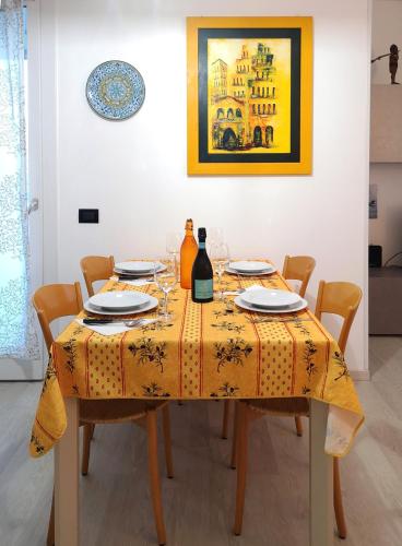 a dining room table with a yellow table cloth at Casa Venezia e Riviera in Mirano