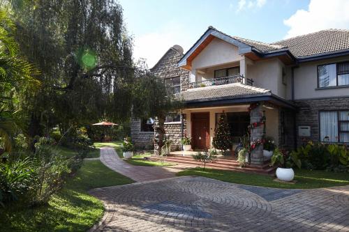a house with a christmas tree in the front yard at Deerpark Luxury Stays in Nairobi