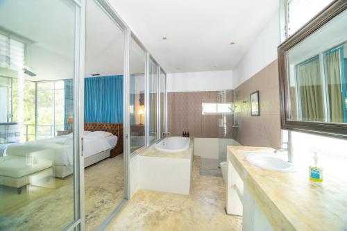 La grande salle de bains est pourvue de 2 lavabos et d'une baignoire. dans l'établissement 8卧沙滩别墅 3女佣 每日清洁 靠近机场 私人泳池 免费用车 健身房, à Phuket