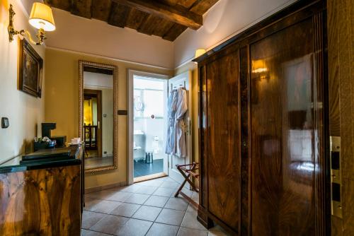 a hallway with a wooden cabinet and a mirror at Golden Well in Prague