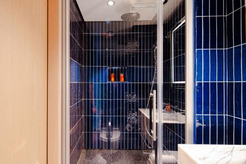 a bathroom with a shower with blue tiles at Stay Lab Taksim in Istanbul