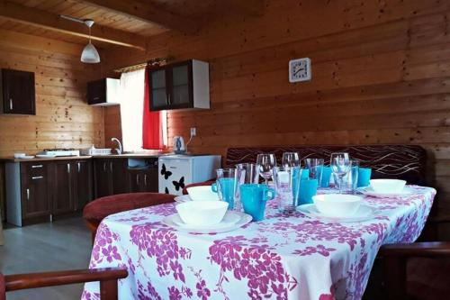 a table in a kitchen with a table cloth on it at Two storey holiday houses for 4 people Jaros awiec in Jarosławiec