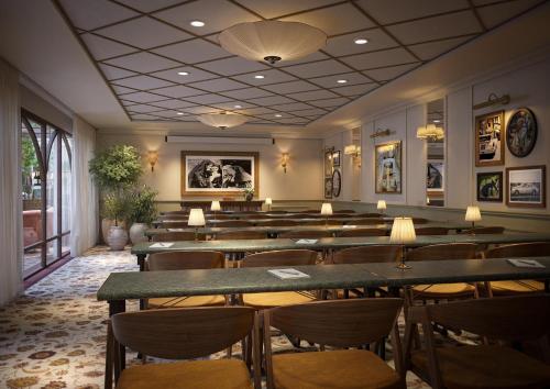 a restaurant with rows of tables and chairs at Hotel & Ristorante Bellora in Gothenburg