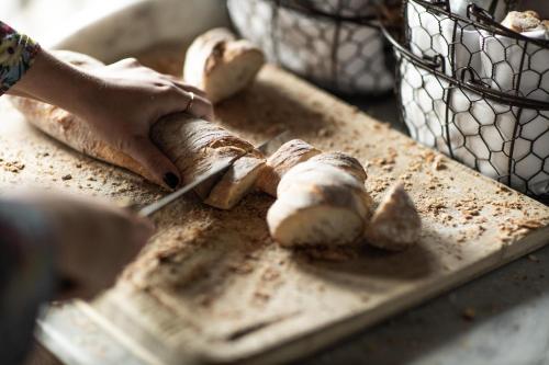 a person cutting up mushrooms on a cutting board at Hotel & Ristorante Bellora in Gothenburg